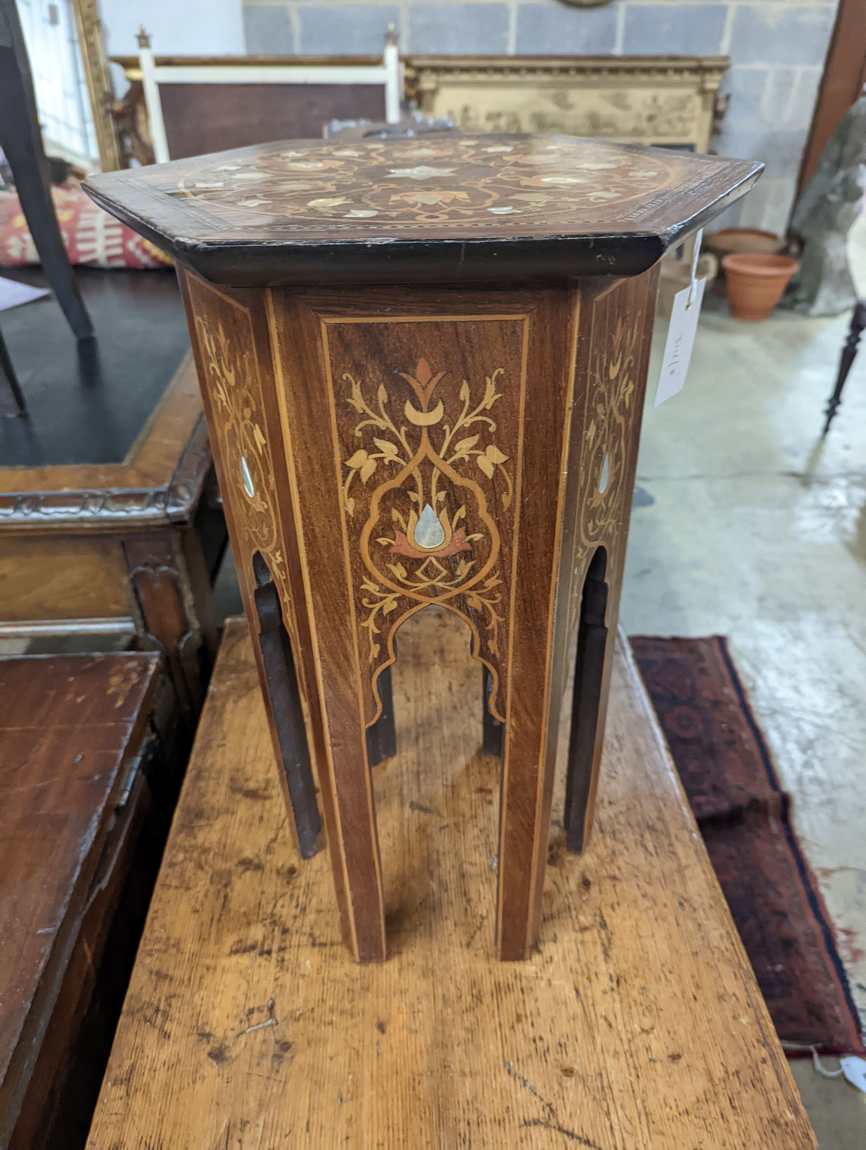 A Moorish mother of pearl and marquetry inlaid hexagonal occasional table, width 29cm, height 50cm